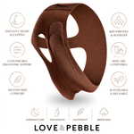 A brown contoured silicone sleep mask shown on a white background with feature callouts and the brand name LOVE & PEBBLE.