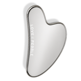 A heart-shaped hand mirror with a polished silver metal frame and a reflective silver mirror surface, featuring the brand name 'LOVE & PEBBLE' vertically printed on the left side, set against a plain white background.