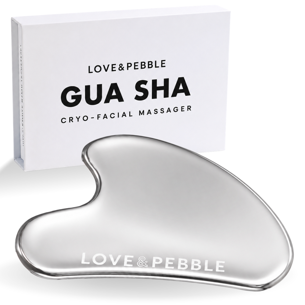 A silver heart-shaped gua sha cryo-facial massager with a white branded box behind it on a clean white background.
