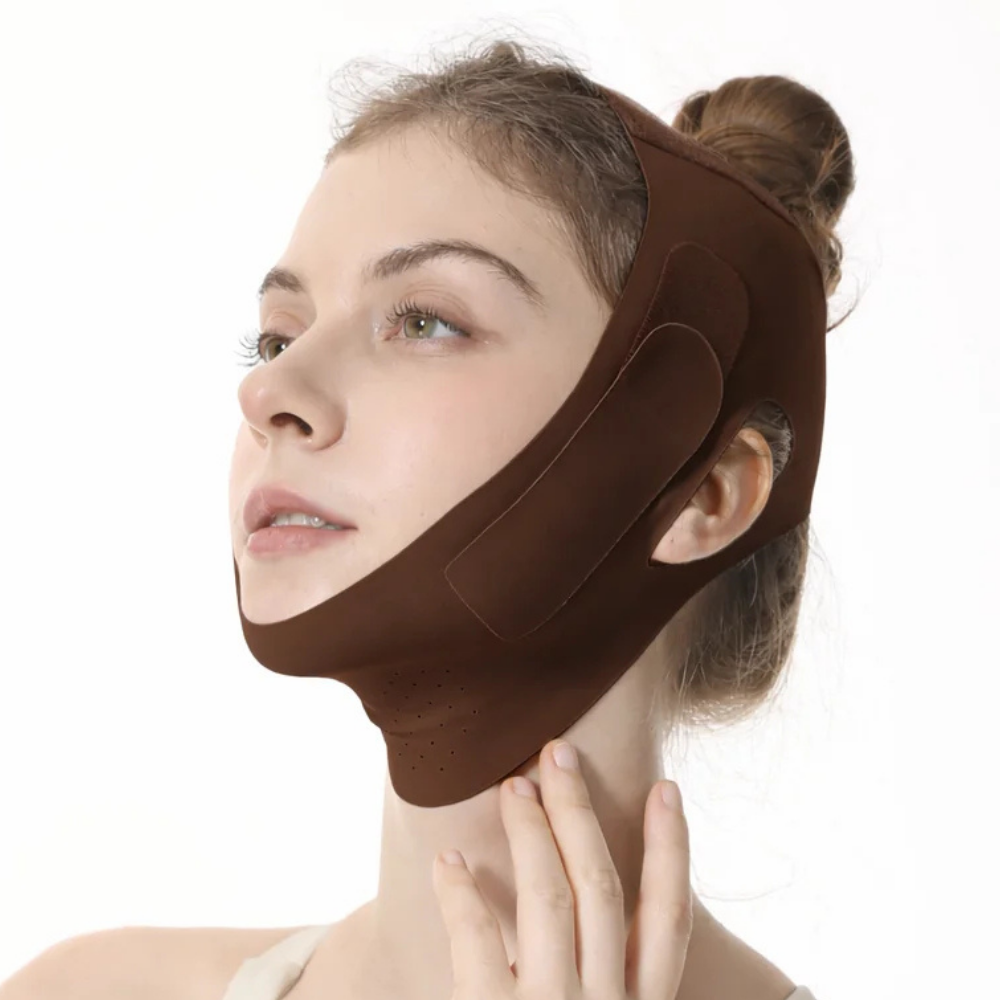 A woman wearing a brown chin and jawline support mask or trimmer, shown from the chest up against a plain white background.