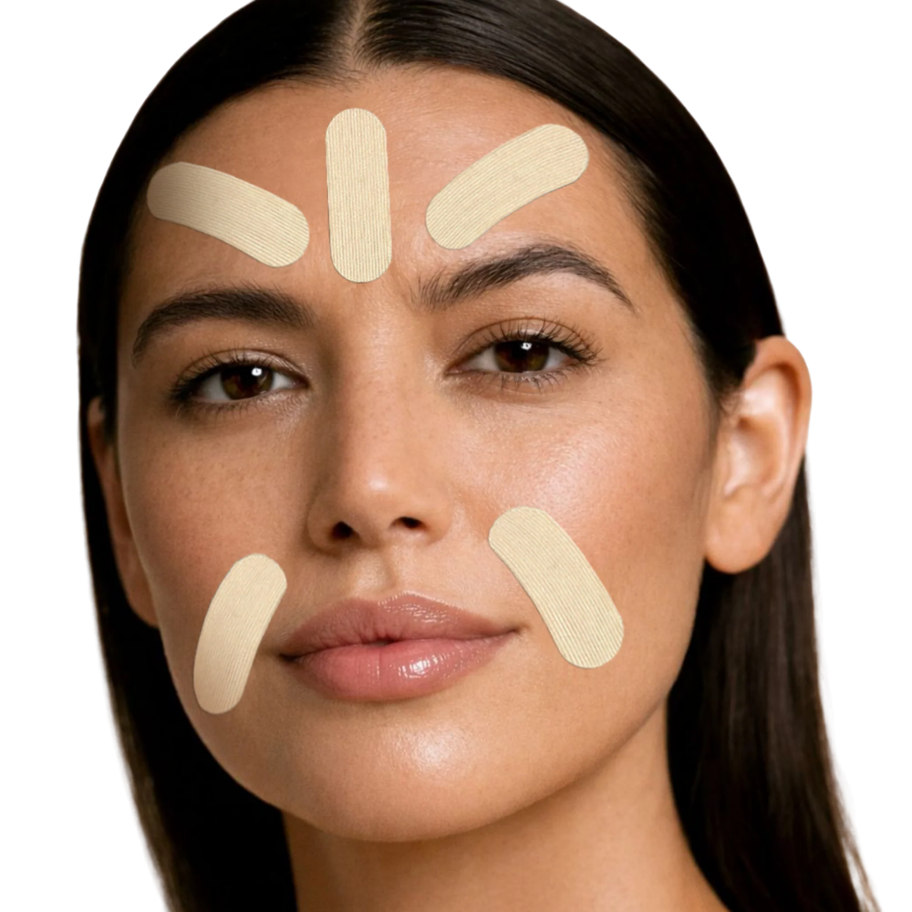 Close-up of a woman's face with five beige adhesive patch strips applied on her forehead, cheeks, and chin against a plain white background.