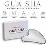 Heart-shaped gua sha cryo-facial massager with a silver metallic finish, shown next to its white packaging box. The image includes feature icons and text describing the benefits of the gua sha massage.